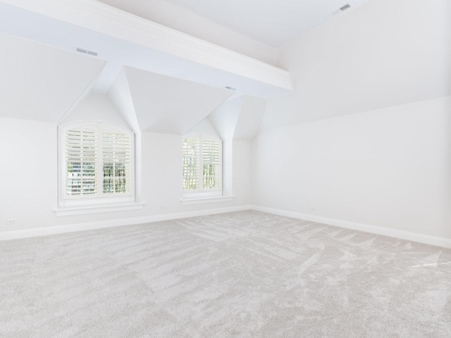 bonus room with vaulted ceiling, carpet floors, visible vents, and baseboards