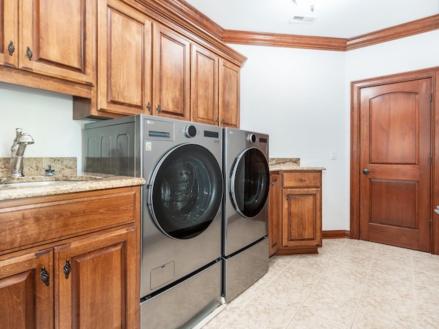 clothes washing area featuring cabinet space, visible vents, ornamental molding, independent washer and dryer, and a sink