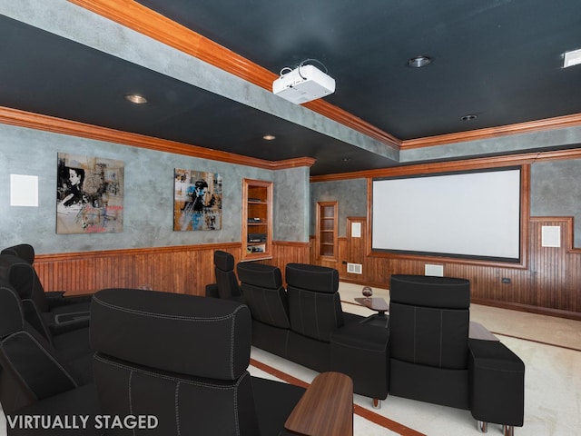 home theater with wooden walls, visible vents, wainscoting, ornamental molding, and carpet flooring