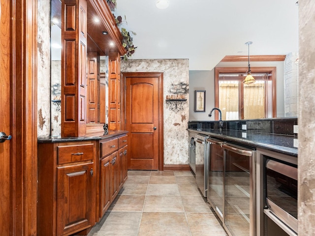 kitchen featuring beverage cooler, a sink, hanging light fixtures, and dishwasher