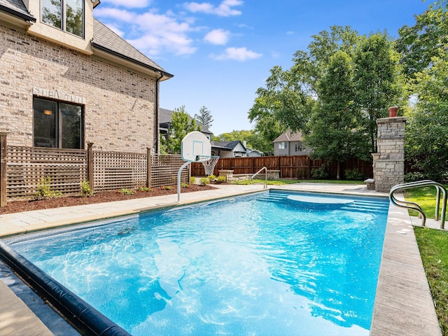 view of swimming pool with fence and a fenced in pool