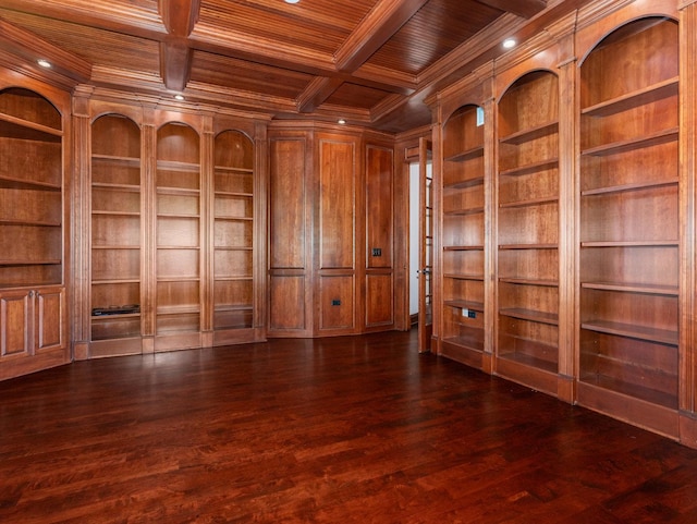 empty room featuring built in features, dark wood-style flooring, ornamental molding, wood ceiling, and coffered ceiling