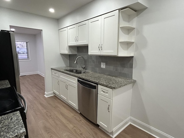 kitchen with dark stone counters, open shelves, white cabinets, and stainless steel appliances