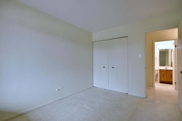 unfurnished bedroom featuring a closet and baseboards