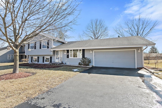 split level home with driveway, an attached garage, a front lawn, and roof with shingles