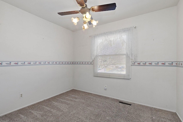 unfurnished room featuring carpet, visible vents, and ceiling fan