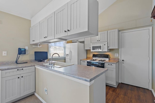 kitchen featuring light countertops, white appliances, a sink, and white cabinetry