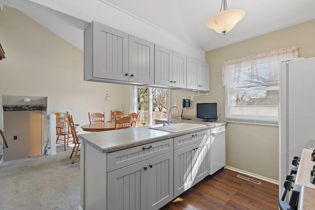 kitchen featuring gray cabinets, a sink, gas range, and pendant lighting