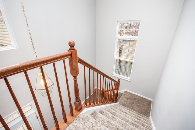 staircase with carpet floors and baseboards