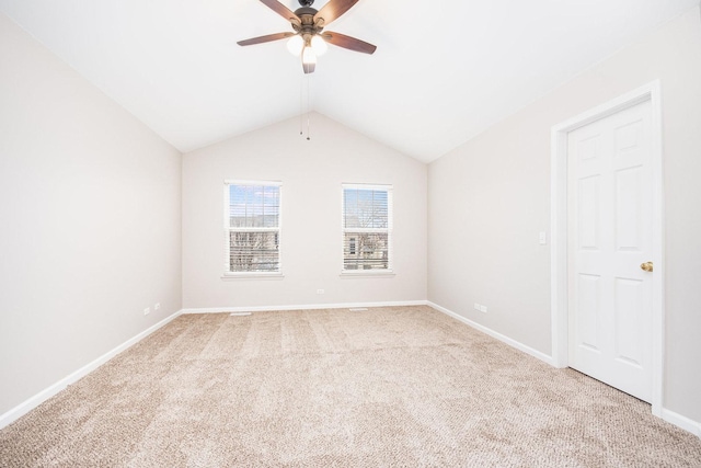 unfurnished room with light carpet, ceiling fan, baseboards, and vaulted ceiling