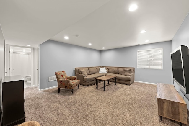 living area with light carpet, baseboards, and visible vents