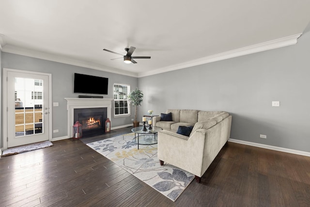 living room with ornamental molding, baseboards, and wood finished floors