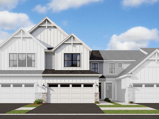 view of front facade with a garage, a shingled roof, aphalt driveway, and board and batten siding