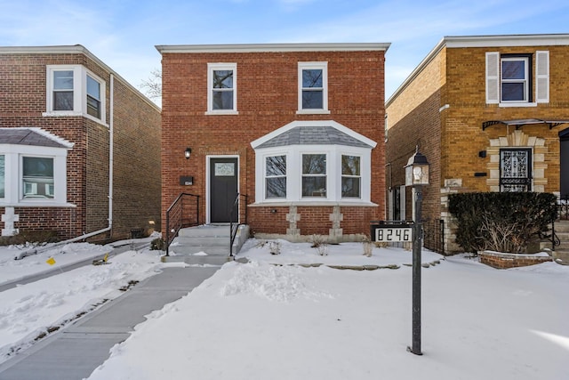 traditional-style home featuring brick siding