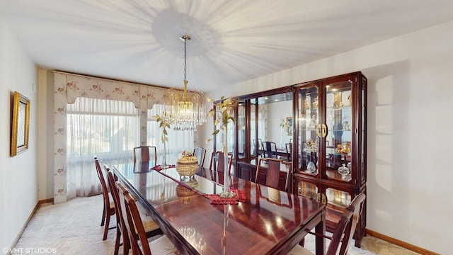 dining space with light carpet, baseboards, and an inviting chandelier