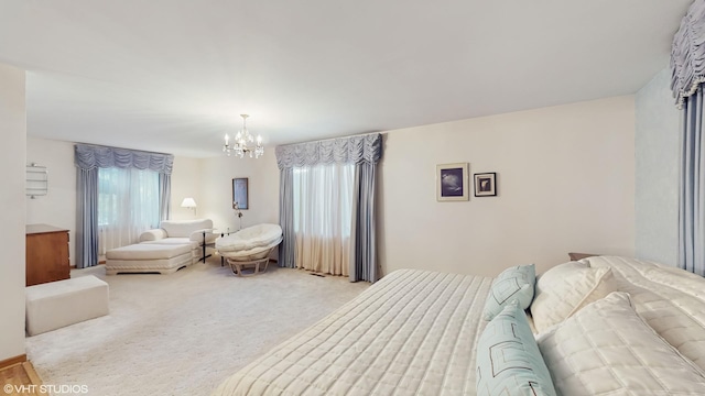 bedroom with a chandelier and light colored carpet