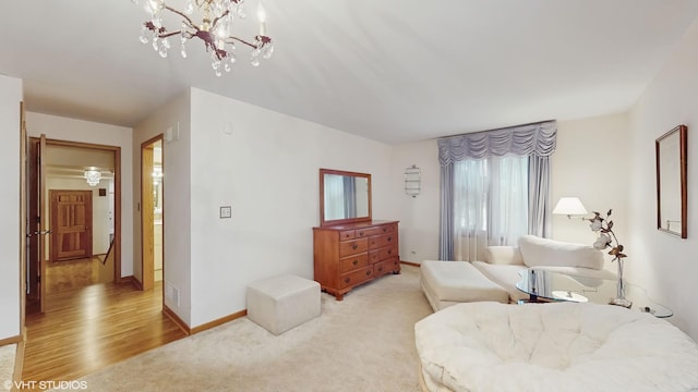 bedroom with light carpet, light wood finished floors, visible vents, and baseboards