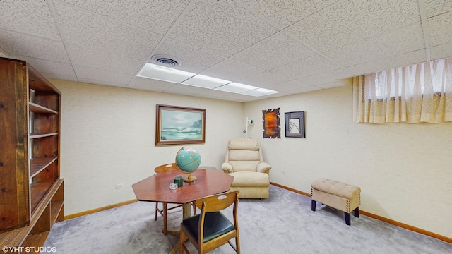 sitting room with a drop ceiling, carpet flooring, visible vents, and baseboards