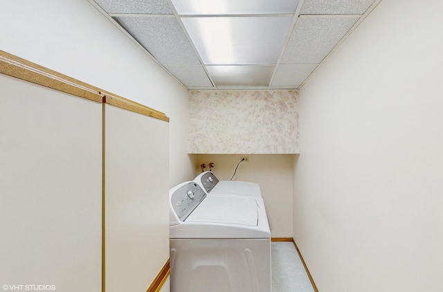 washroom featuring laundry area, washer and clothes dryer, and baseboards