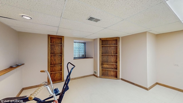 workout room with visible vents, baseboards, and tile patterned floors