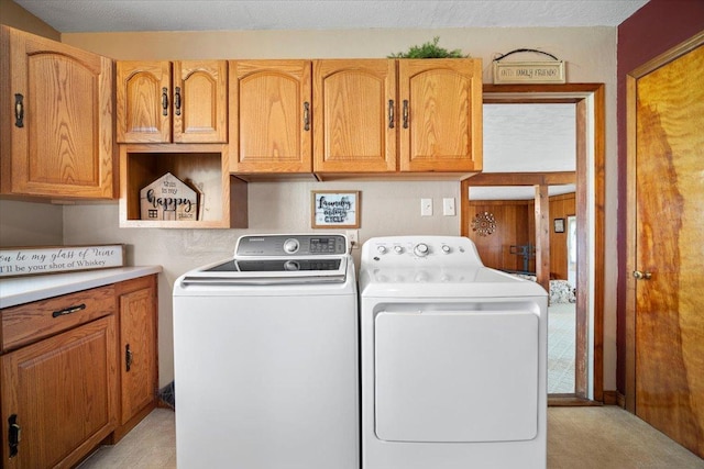 washroom featuring cabinet space and washing machine and clothes dryer