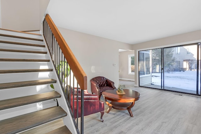 interior space featuring baseboards, visible vents, and wood finished floors