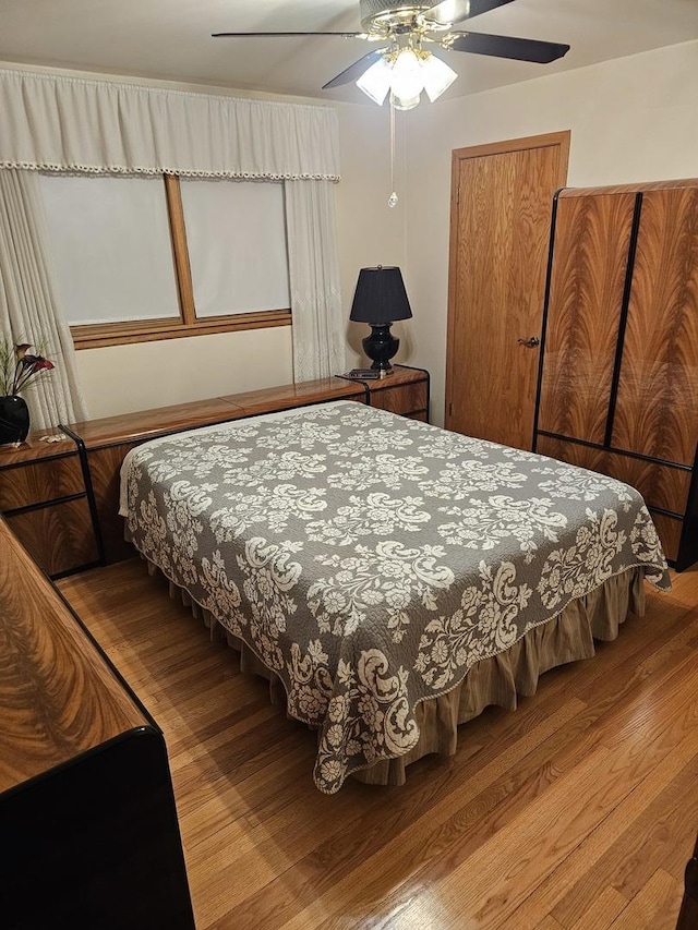 bedroom with ceiling fan and wood finished floors