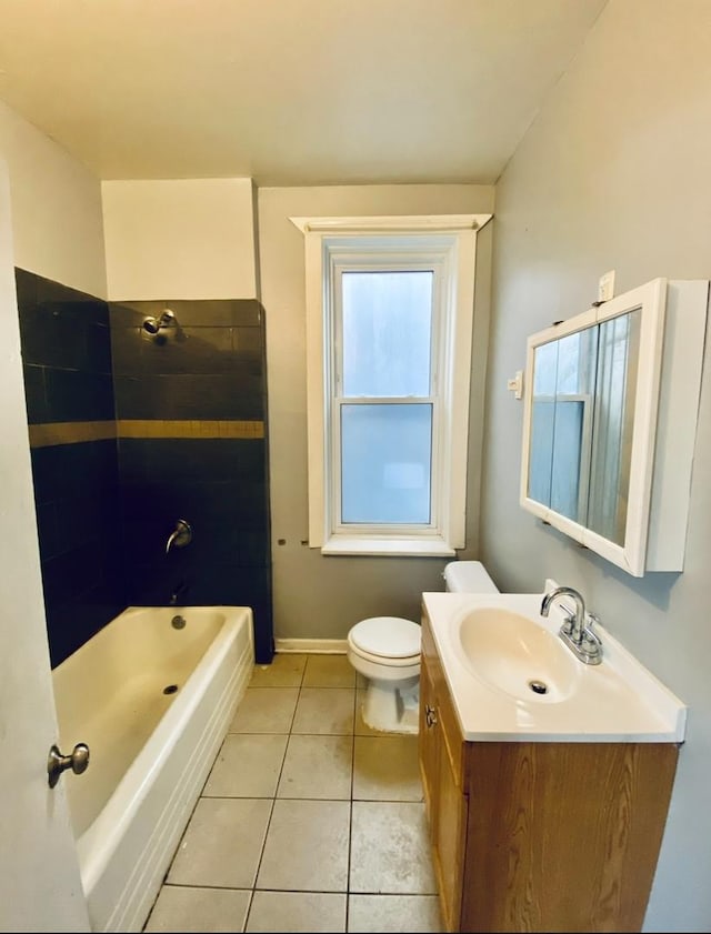 full bathroom with shower / bathtub combination, toilet, vanity, tile patterned flooring, and baseboards