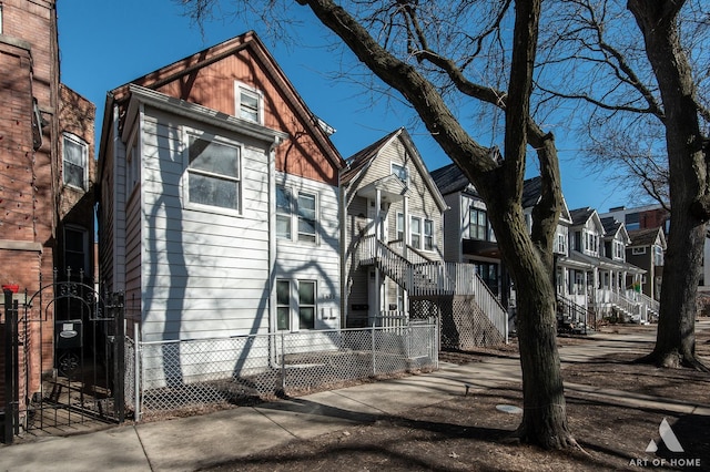 townhome / multi-family property with a fenced front yard and a residential view