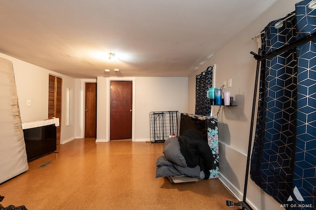 interior space featuring baseboards and visible vents