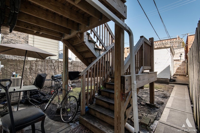 view of patio / terrace featuring stairs and fence