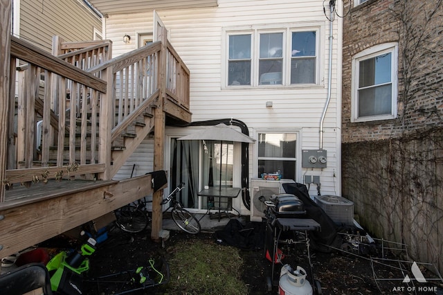 rear view of property with stairway and central AC unit