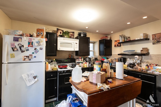 kitchen featuring white appliances, tasteful backsplash, and dark cabinetry