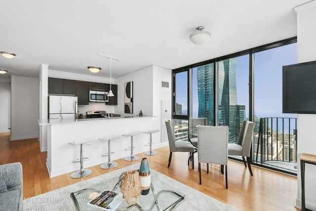 225 N Columbus Dr Unit 5610, Chicago, IL 60601 - kitchen featuring freestanding refrigerator, stainless steel microwave, stove, healthy amount of natural light, and expansive windows