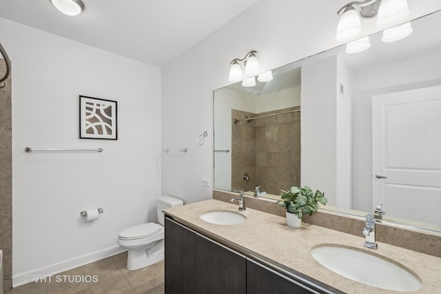 225 N Columbus Dr Unit 5610, Chicago, IL 60601 - bathroom featuring toilet, double vanity, tile patterned floors, a tile shower, and baseboards