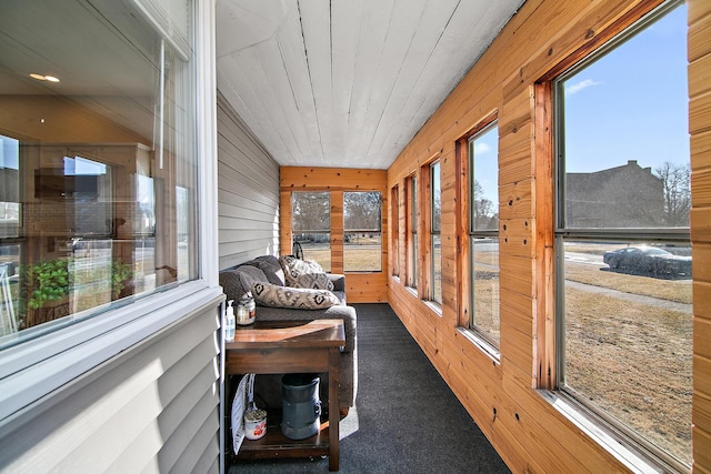 sunroom with a healthy amount of sunlight and wood ceiling