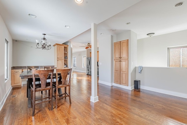 dining area with recessed lighting, visible vents, baseboards, light wood-style flooring, and ceiling fan with notable chandelier