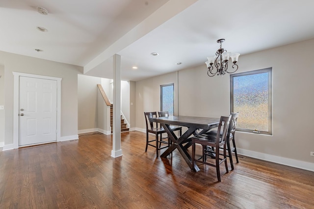 dining area featuring dark wood-style flooring, plenty of natural light, baseboards, and stairs