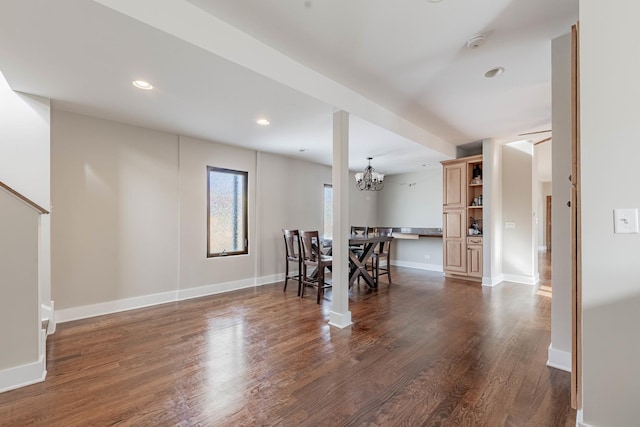 unfurnished dining area featuring baseboards, a chandelier, dark wood-type flooring, and recessed lighting