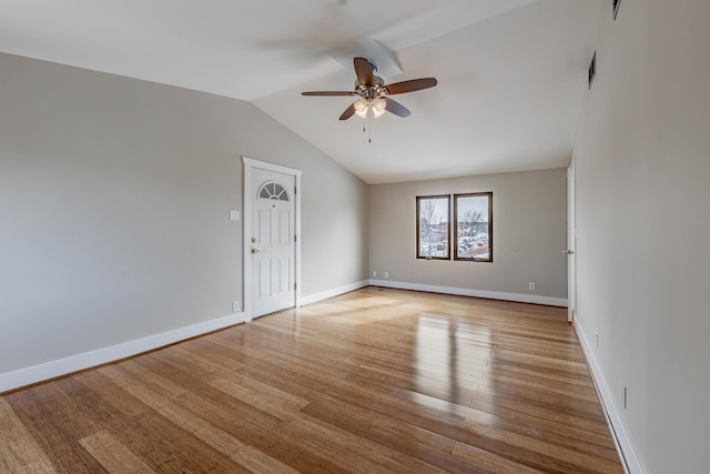 spare room with visible vents, baseboards, a ceiling fan, lofted ceiling, and light wood-style flooring