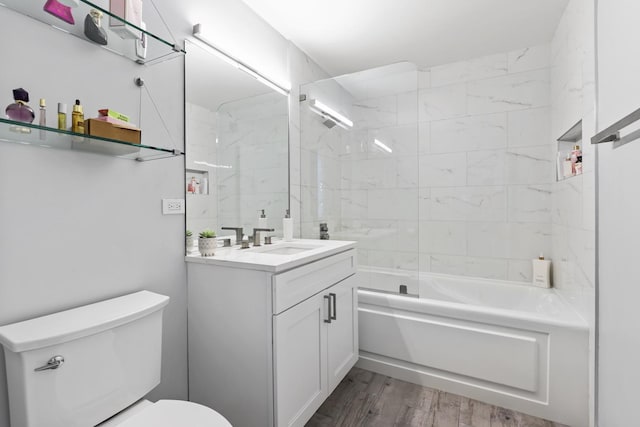 bathroom featuring vanity,  shower combination, wood finished floors, and toilet