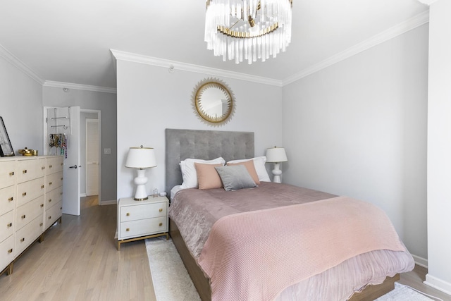 bedroom with light wood-style floors, crown molding, a notable chandelier, and baseboards