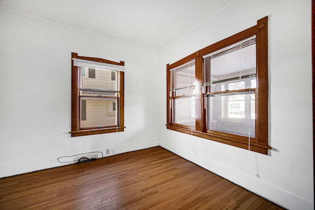 empty room with baseboards and wood finished floors