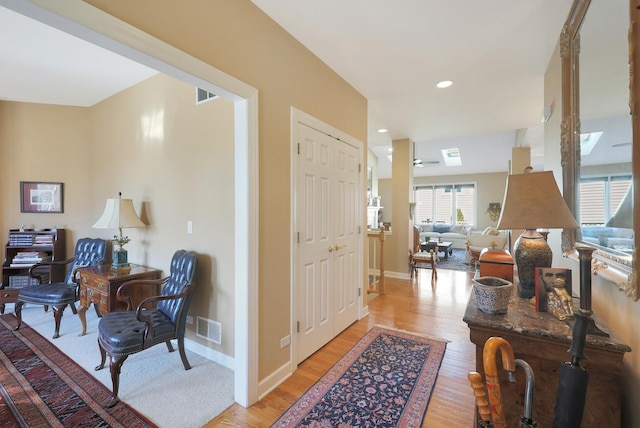 foyer with recessed lighting, visible vents, light wood-style flooring, and baseboards