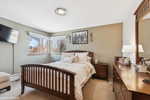 bedroom with light carpet and a baseboard radiator