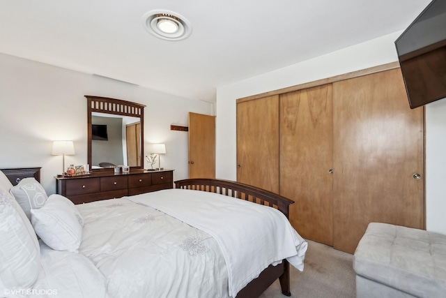 bedroom with light carpet and a closet