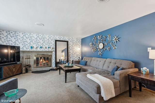 living room with carpet flooring, a glass covered fireplace, and wallpapered walls