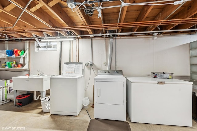 laundry area with a sink, laundry area, and washing machine and clothes dryer