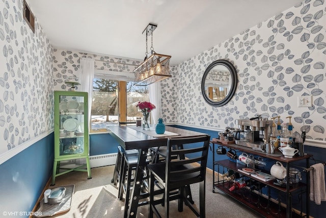 dining area featuring wainscoting, carpet flooring, and wallpapered walls