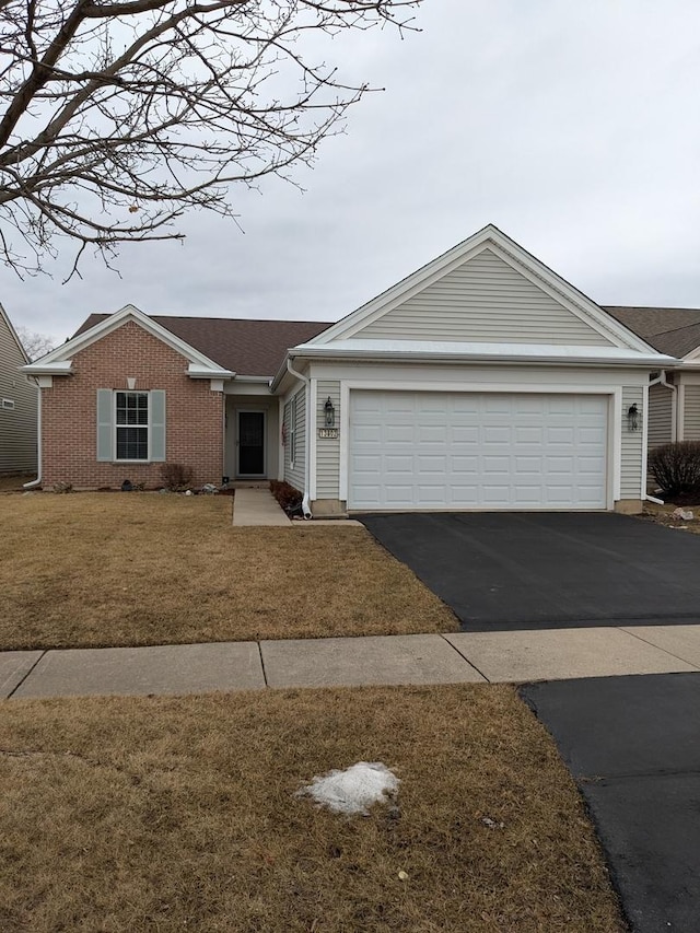 ranch-style home featuring a garage, brick siding, a shingled roof, aphalt driveway, and a front yard